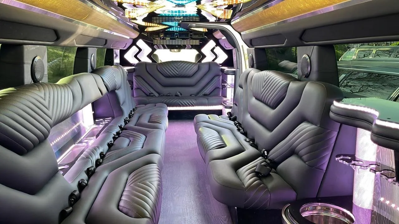White Hummer limo interior with wrap-around leather seating and color-changing LED lighting, Smart Limo Rental DC