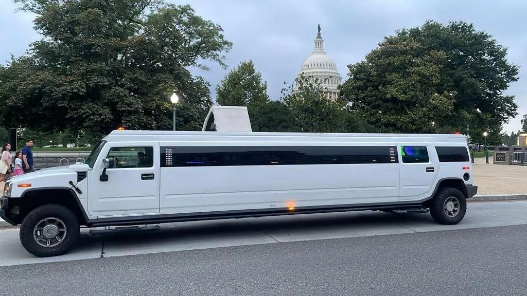 White Hummer H2 stretch limousine parked in front of the US Capitol dome, 18-passenger DC limo, Smart Limo Rental Washington DC