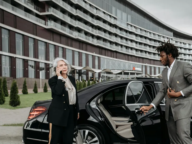 Smart Limo Rental chauffeur opening the door of an executive sedan for a Washington DC corporate client